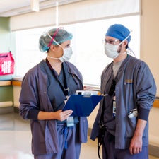 University of Virginia UVA Dr. Ashley Garneau, M.D. guides Resident Tyler Johnson, M.D. in Obstetrics patient care.