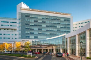 outdoor view of the front of the white and blue-green hospital